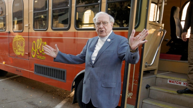 Warren Buffett arrives in a trolley he rented to take voters to their polling station