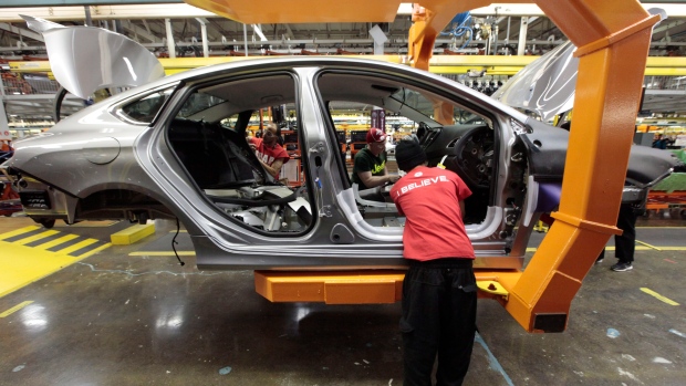  assembly line workers build a 2015 Chrysler 200 automobile at the Sterling Heights assembly plant