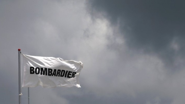 A Bombardier flag flutters amidst storm clouds at the Singapore Airshow