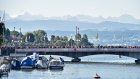 Spectators watch the men's marathon on Zurich's Quay Bridge backdropped by the Swiss alps