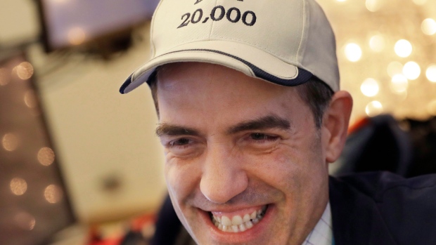Stock trader Gregory Rowe wears 'Dow 20,000' hat at the New York Stock Exchange. 