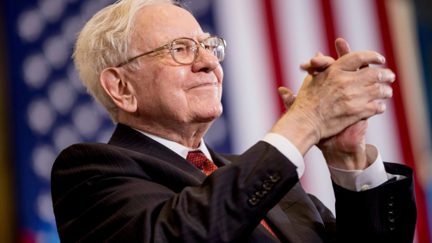  Warren Buffett applauds at a rally for Hillary Clinton in Omaha, Neb.