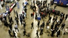 Job seekers visit corporate employment personnel at a job fair in Washington