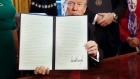 President Donald Trump holds up an executive order after his signing on Feb. 3, 2017. 