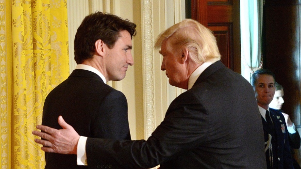Justin Trudeau and Donald Trump shake hands after a joint press conference. 