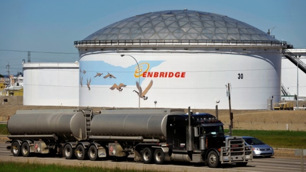 A storage tank looms over a freeway at the Enbridge Edmonton terminal