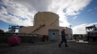 A FortisBC employee walks past a storage tank at the existing Tilbury LNG facility