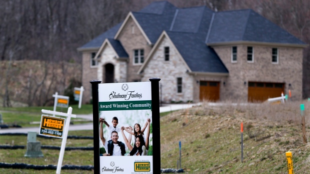 Real estate signs mark the lots near one of the new homes for sale in in Cranberry Township, Pa.