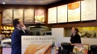 A customer reviews the sandwich board at the Panera store in Brookline, Mass.