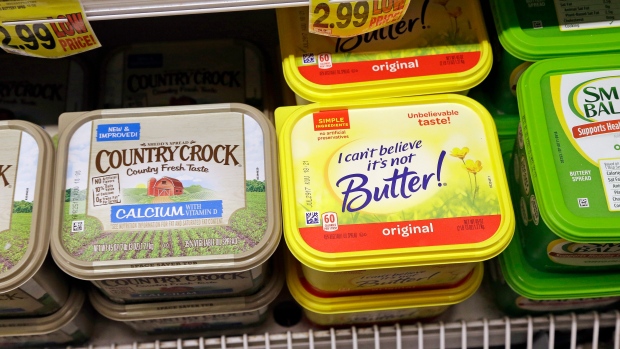 Containers of I Can't Believe It's Not Butter and Country Crock on display in a grocery store