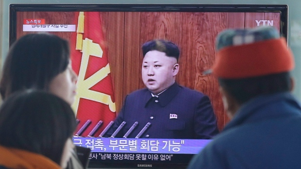 People in Seoul watch a TV news program showing North Korean leader Kim Jong-Un delivering a speech