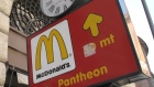  a sign pointing to the McDonald's restaurant near the historic Pantheon in Rome