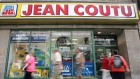 Pedestrians walk past a Jean Coutu pharmacy in Montreal