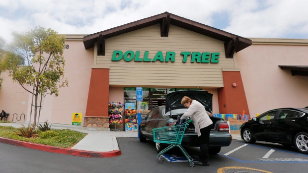 A shopper searches her purse outside a Dollar Tree store in Encinitas, Calif. Dollar Tree