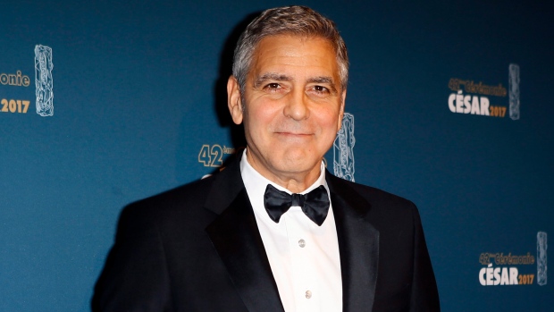 George Clooney poses with the Honorary Cesar award in 2017