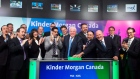 Ian Anderson, centre, President, Kinder Morgan Canada Limited opens the market in Toronto
