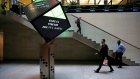 People walk through the lobby of the London Stock Exchange in London