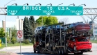 A car hauler heading for Detroit, Michigan, drives on the lane to Ambassador Bridge in Windsor, Onta