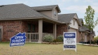 U.S. real estate signs at a new home community in Edmond, Okla.