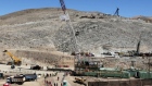 Giant dump trucks dump raw tar sands for processing at the Suncor tar sands mining operations  