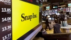 In this Monday, Aug. 7, 2017, photo, the Snap Inc. logo appears on a screen above a trading post on 