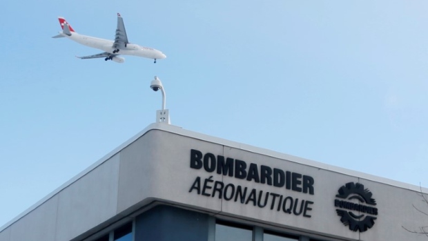 A plane flies over a Bombardier plant in Montreal, Quebec