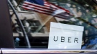 An Uber sign is seen in a car in New York