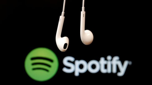 Headphones are seen in front of a logo of online music streaming service Spotify in this February 18