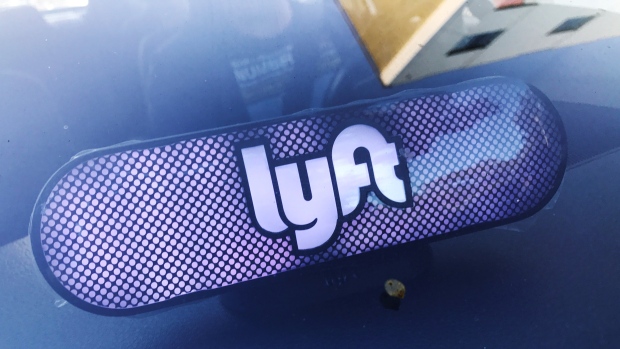 An illuminated sign appears in a Lyft ride-hailing car