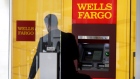 A man walks by a bank machine at the Wells Fargo & Co. bank in downtown Denver, Colorado
