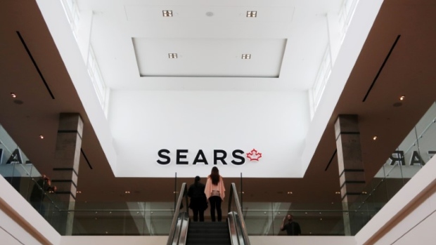 People take an escalator to a Sears store in Mississauga, Ontario, October 6, 2017