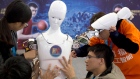 In this Oct. 21, 2016, file photo, Chinese students work on the Ares, a humanoid bipedal robot 