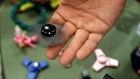 A toy store owner Tom Jones plays with a fidget spinner in Oxford, Mich. 