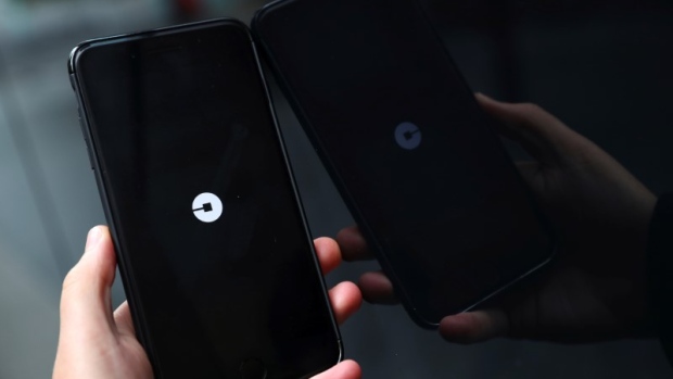 The Uber logo is seen on mobile telephone in London, Britain, September 25, 2017