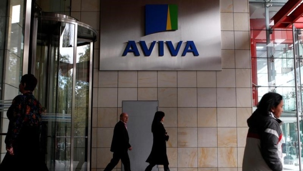 People enter and exit the AVIVA headquarters building in Dublin October 19, 2011