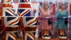 Figures of Britain's Queen Elizabeth are displayed for sale in a shop in central London