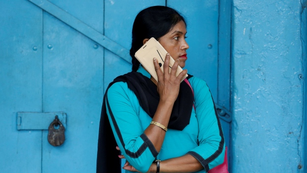 A woman talks on her mobile phone on a pavement in Kolkata, India July 5, 2017