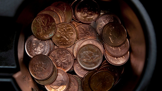 A handful of one cent coins is seen in a passenger car cupholder in Dartmouth, N.S.