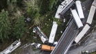 Cars from an Amtrak train that derailed above lie spilled onto Interstate 5, Monday, Dec. 18, 2017, 