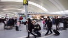 People carry luggage at Pearson International Airport in Toronto on December 20, 2013.