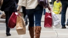A woman carries shopping bags during the Christmas shopping season in Toronto, December 7, 2012