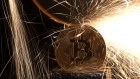Sparks glow from broken bitcoin coins in this illustration picture, December 8, 2017