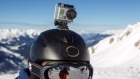GoPro camera on a skier's helmet as he rides down the slopes in the ski resort, French Alps