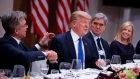 President Donald Trump listens during a dinner with European business leaders in Davos