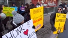 Protesters stand outside a Tim Hortons