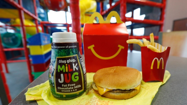 A Happy Meal featuring non-fat chocolate milk and a cheeseburger with fries