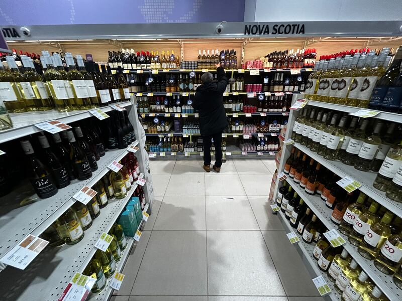 A shopper reaches for a bottle of Nova 7 wine at an NSLC location. (Jonathan MacInnis/CTV Atlantic)