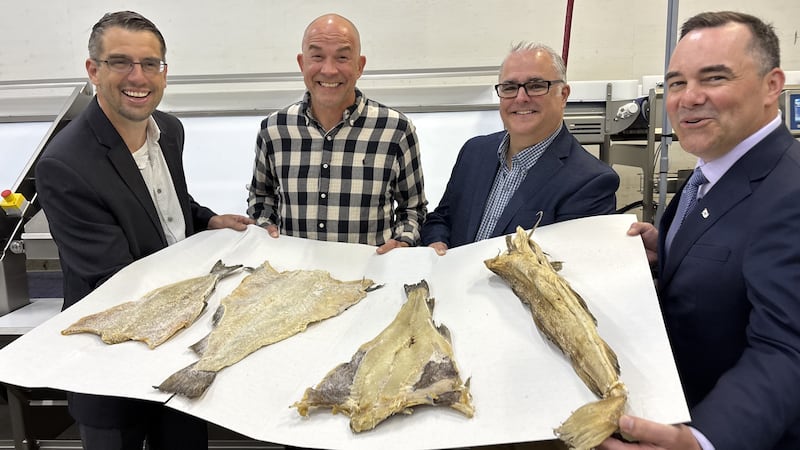 Officials holding fish
