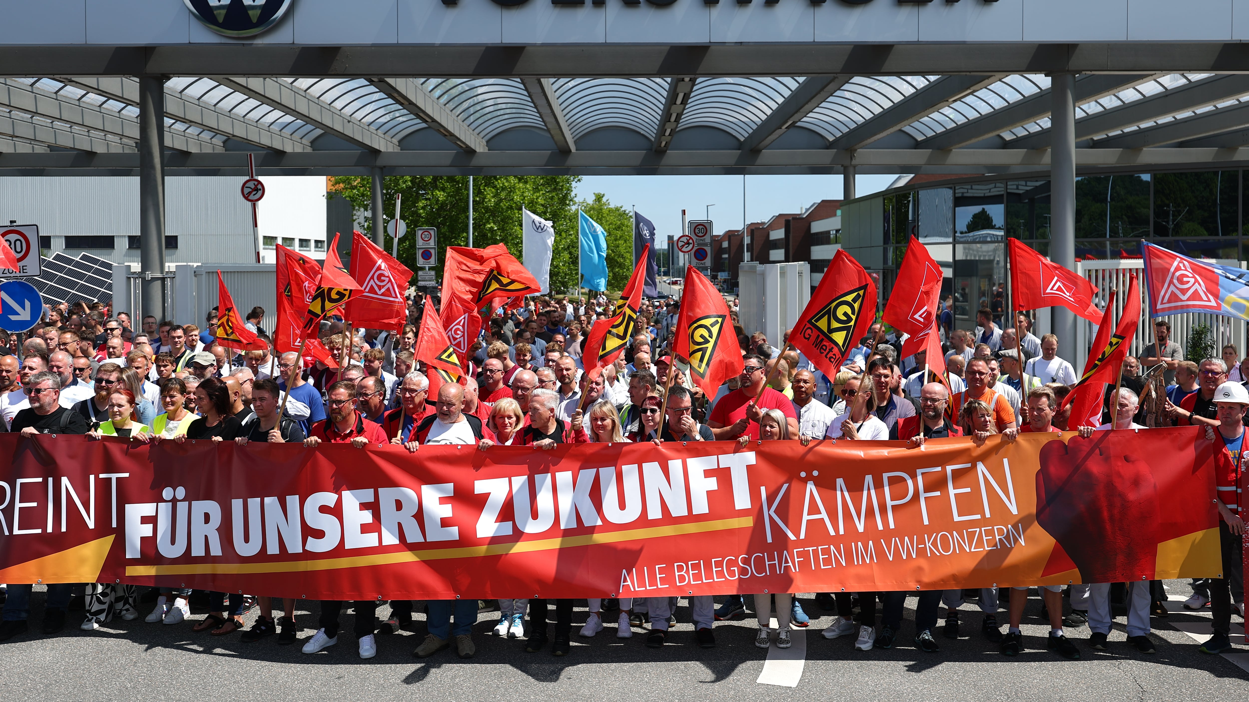 Workers protest Volkswagen's restructuring plans in front of the automaker's plant in Zwickau, Germany, on July 9, 2026. (Jan Woitas / dpa via AP)