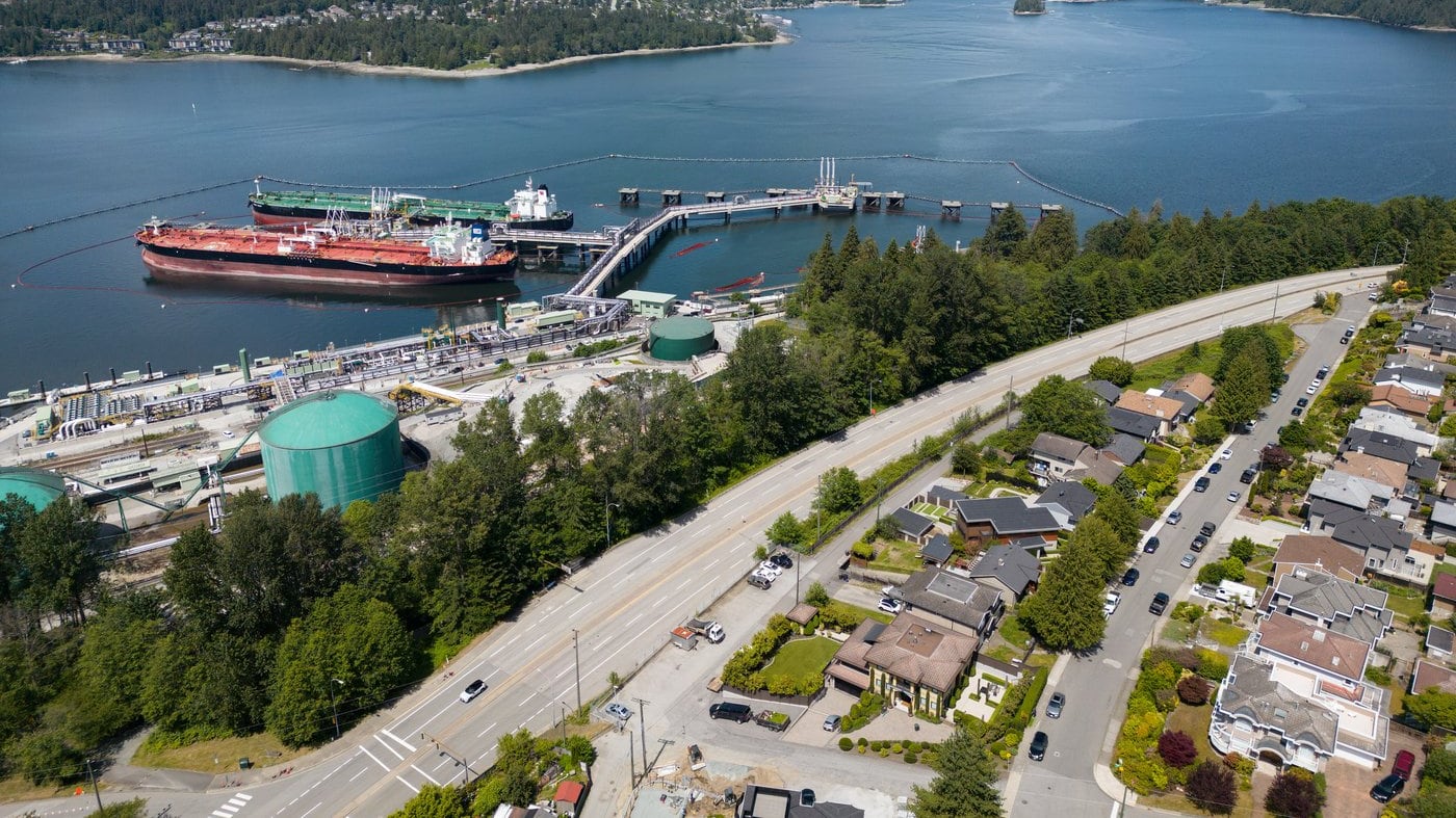 Crude oil tankers SFL Sabine, front left, and Tarbet Spirit are seen docked at the Trans Mountain Westridge Marine Terminal, where crude oil from the expanded Trans Mountain Pipeline is loaded onto tankers, near a residential area in Burnaby, B.C., Monday, June 10, 2024. (THE CANADIAN PRESS/Darryl Dyck)